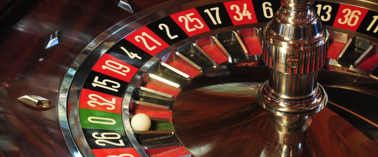 Roulette wheel close-up with ball in the zero pocket